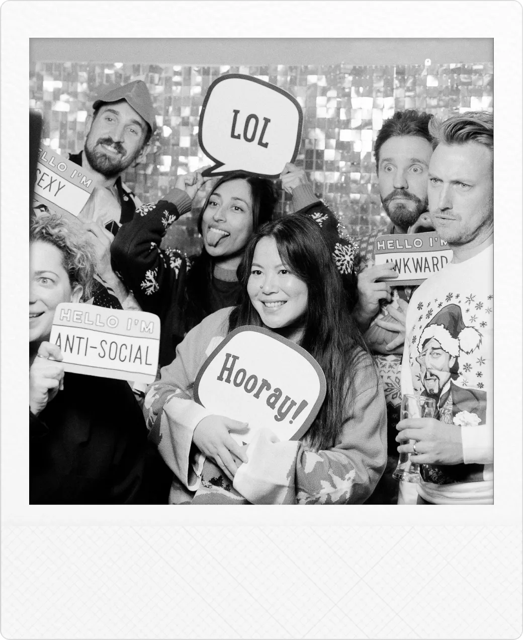 A group of Buildkite employees holding photobooth signs